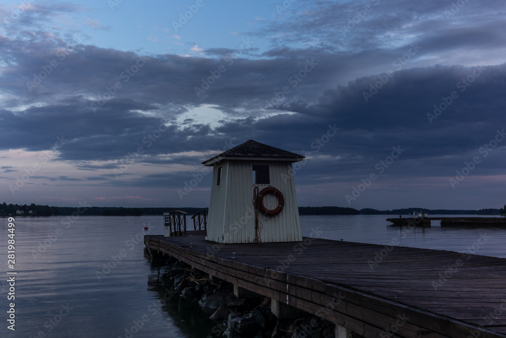 A traditional lifeguard and changing dress shelter on a wooden pier near the town of Porvoo in Finland at sunset in summer - 1
