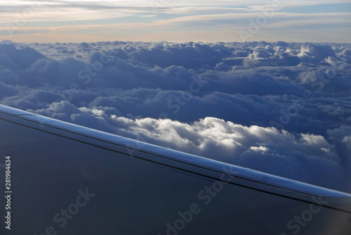 aerial view from plane at clouds with part of wing © Dietlinde DuPlessis