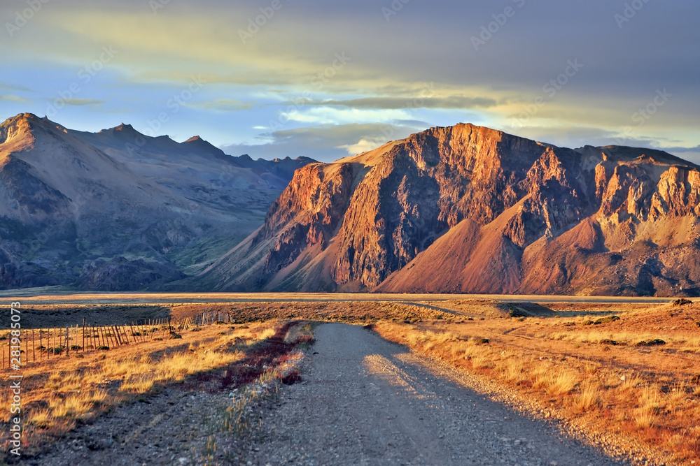 Naklejka premium The gravel road between the endless pampas