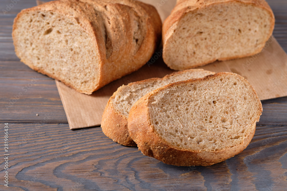 Bread with bran, sliced on an wooden table, selective focus. Homemade bread