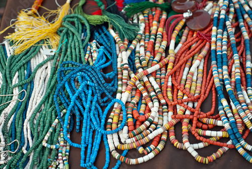Necklace of colorful stones on the table. Many different jewelry and beads made of natural precious minerals. Stones jewelry is on sale at the fair.