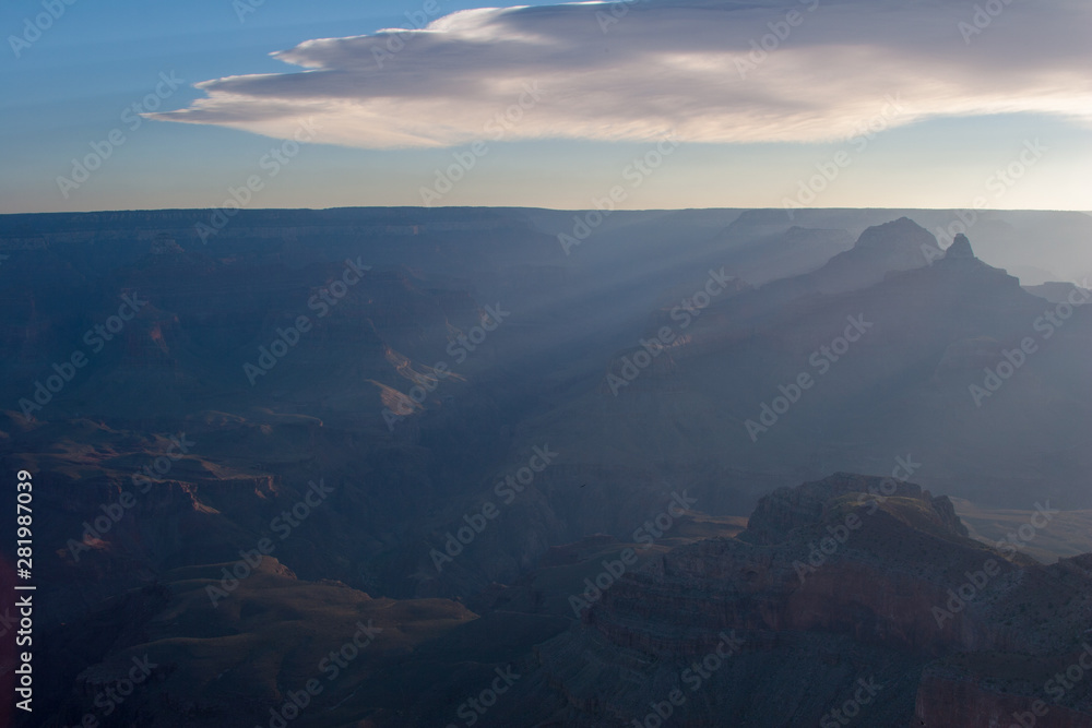 Sun rays at sunrise from Mather Point on South Rim of Grand Canyon National Park, Arizona in summer.