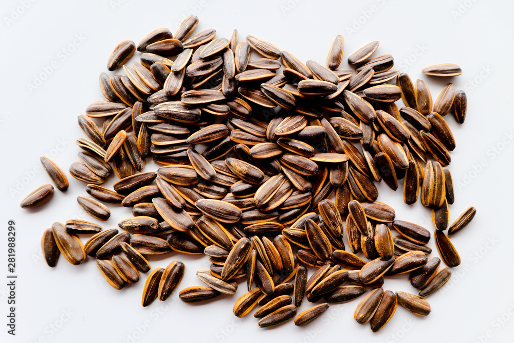 Abstract close up sunflower seeds on the white isolated background and wallpaper Abstract close up sunflower seeds on the white isolated background and wallpaper