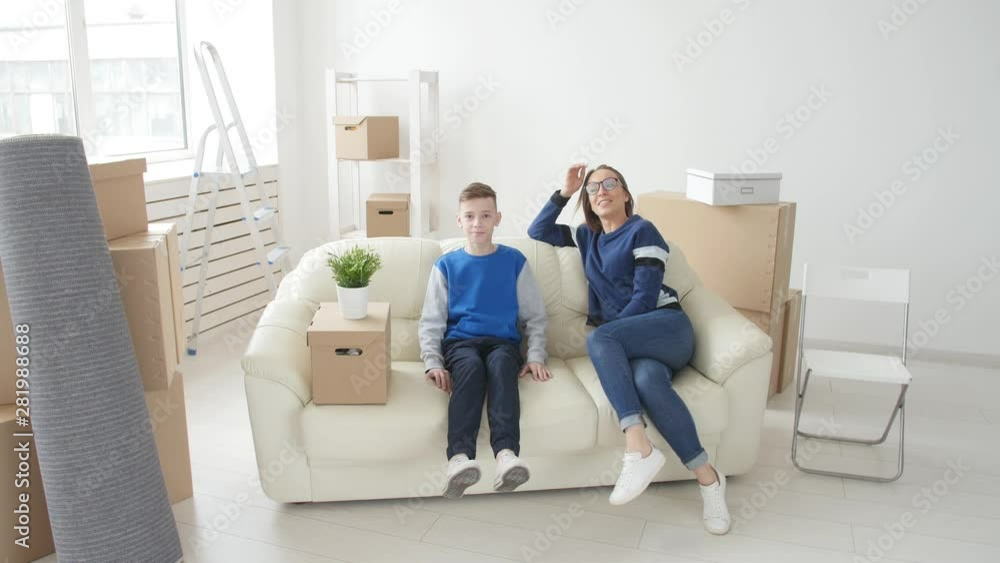 Young Mom and son with their cat are moving to a new apartment Young Mom and son with their cat are moving to a new apartment