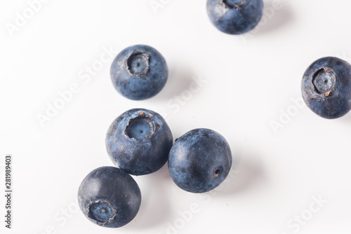 Many red and white berry.Good tasting blueberries with full of healthy vitamins..A good vegan meal. Set of tasty blueberries on white background, closeup.