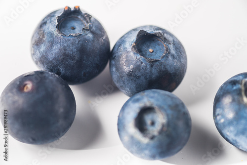 Many red and white berry.Good tasting blueberries with full of healthy vitamins..A good vegan meal. Set of tasty blueberries on white background, closeup.