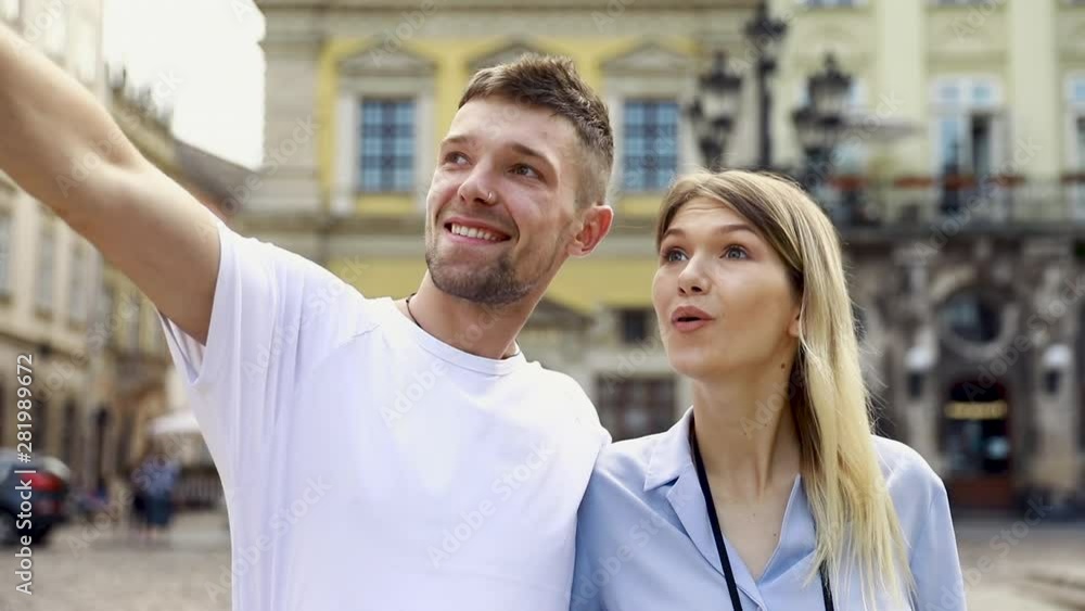 Travel. Tourist Couple Traveling, Walking On Street. Portrait Of Beautiful Young Woman And Handsome Man In Stylish Clothes Sightseeing City Attractions, Looking At Architecture. High Resolution. Travel. Tourist Couple Traveling, Walking On Street. Portrait Of Beautiful Young Woman And Handsome Man In Stylish Clothes Sightseeing City Attractions, Looking At Architecture. High Resolution.