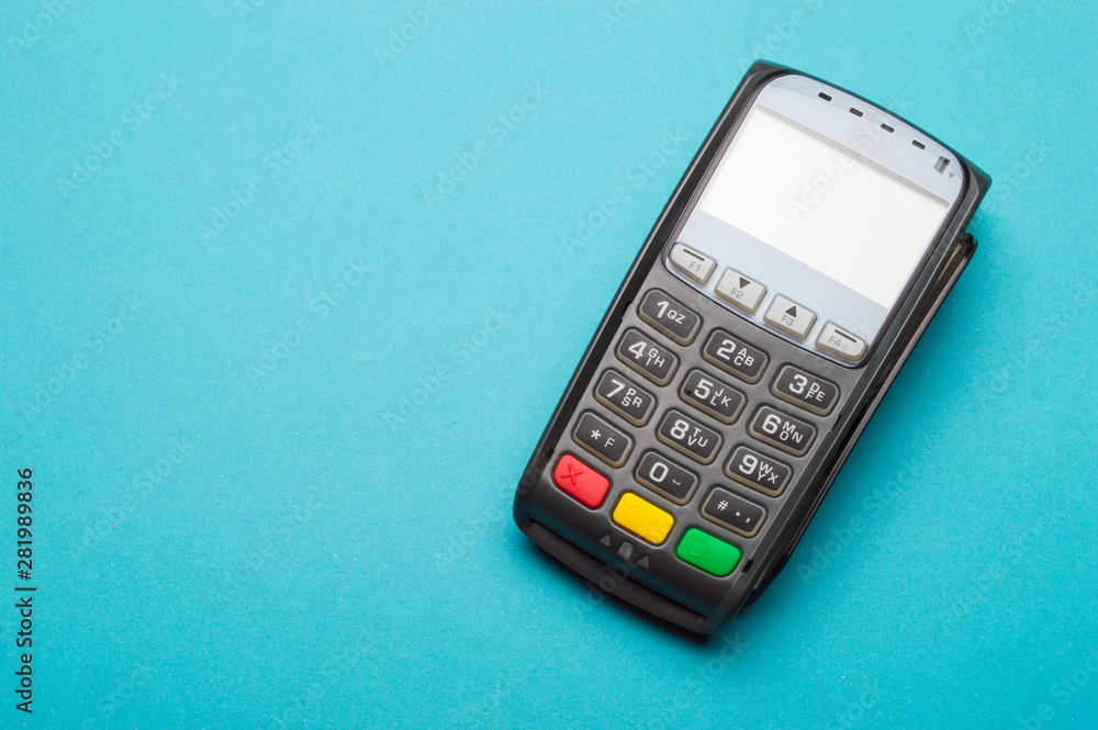 Credit card terminal on blue background. Close up of merchant payment device, card machine. Credit card terminal on blue background. Close up of merchant payment device, card machine.