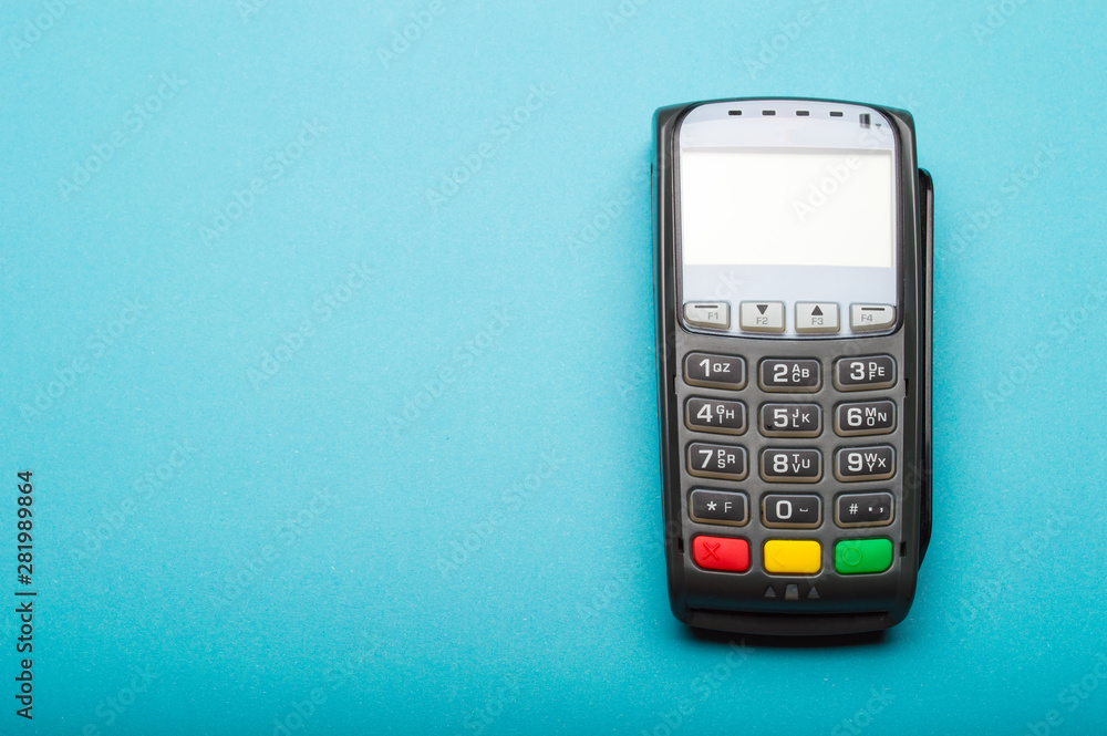 Credit card terminal on blue background. Close up of merchant payment device, card machine. Credit card terminal on blue background. Close up of merchant payment device, card machine.