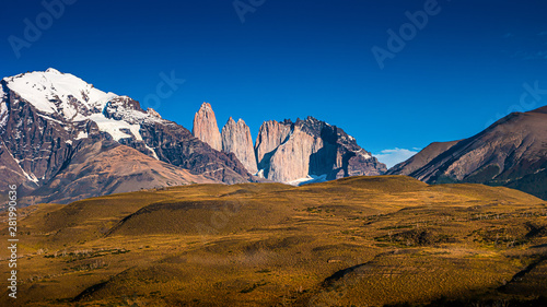Torres del Paine National Park, its forests and summits at golden Autumn and blue sky, Patagonia, Chile
