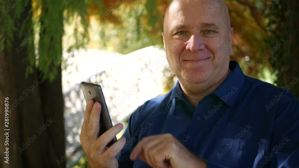 Businessman on Park Alley Read a Message from Smartphone and Smile to Camera Businessman on Park Alley Read a Message from Smartphone and Smile to Camera