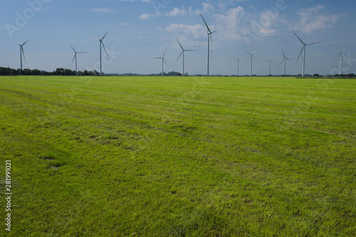 Windpark und abgemähte Wiese im Wangerland in Niedersachsen an der Nordseeküste - Stockfoto