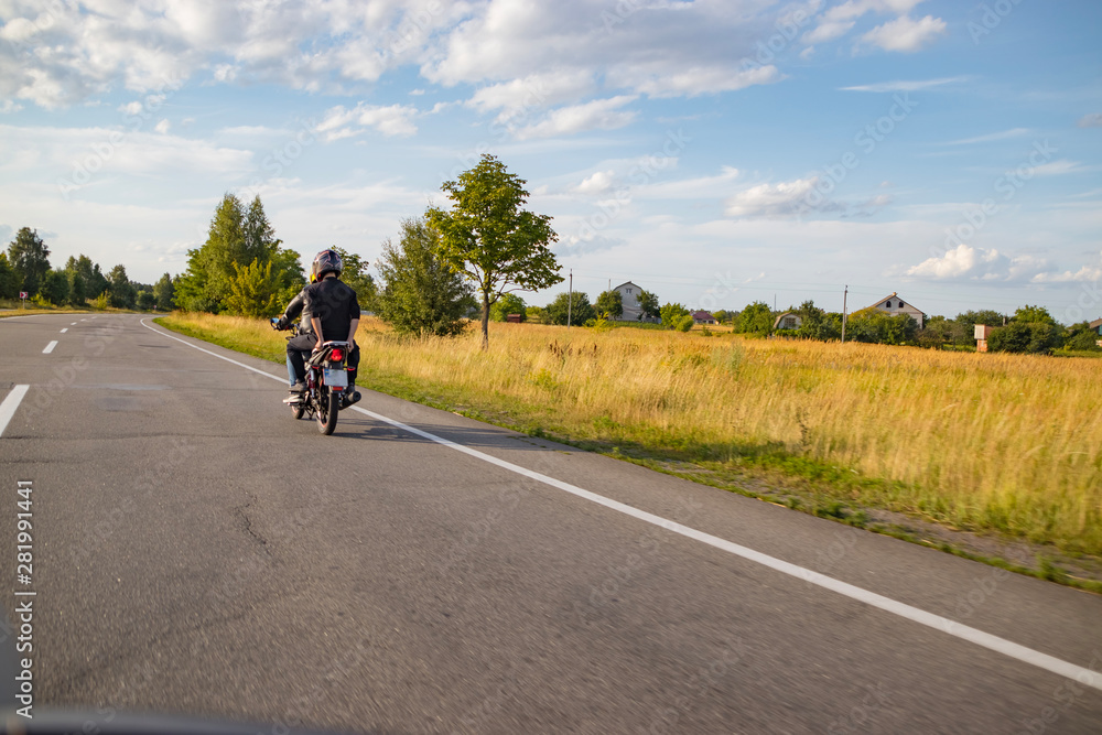 Motorcyclist biker driving on the highway Motorcyclist biker driving on the highway