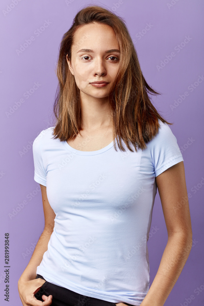 pleasant girl has pigmentation spots which have been formed because of excessive sunburn, close up portrait, isolated blue background, studio shot. pleasant girl has pigmentation spots which have been formed because of excessive sunburn, close up portrait, isolated blue background, studio shot.