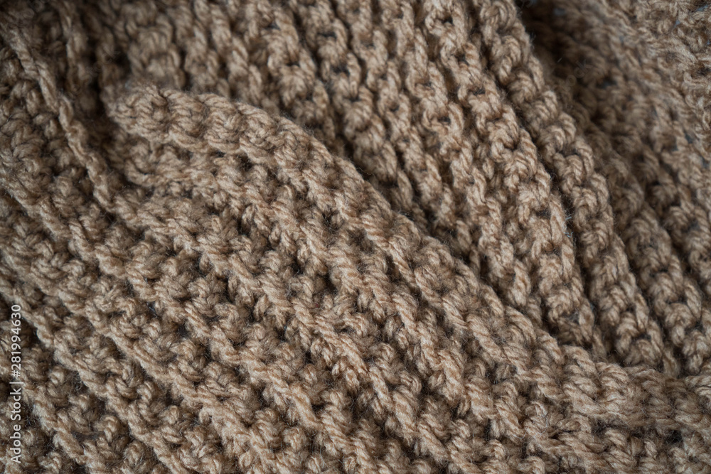 Knitted horizontal textured brown fabric on a white background. Fragment of a brown color sweater. Texture, close up. For yarn, clothing, needlework store, flyer design, banner, for site Knitted horizontal textured brown fabric on a white background. Fragment of a brown color sweater. Texture, close up. For yarn, clothing, needlework store, flyer design, banner, for site