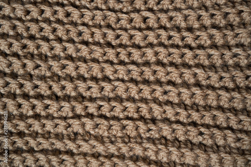 Knitted horizontal textured brown fabric on a white background. Fragment of a brown color sweater. Texture, close up. For yarn, clothing, needlework store, flyer design, banner, for site