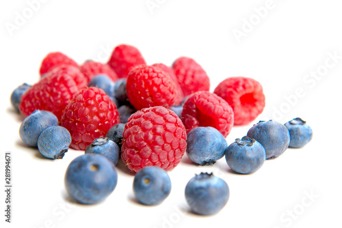 Mix berries isolated on white background. Ripe raspberry and blueberries.
