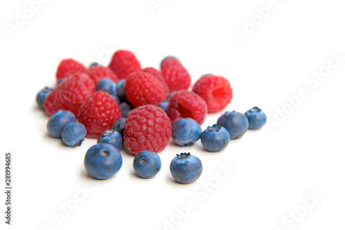 Mix berries isolated on white background. Ripe raspberry and blueberries.