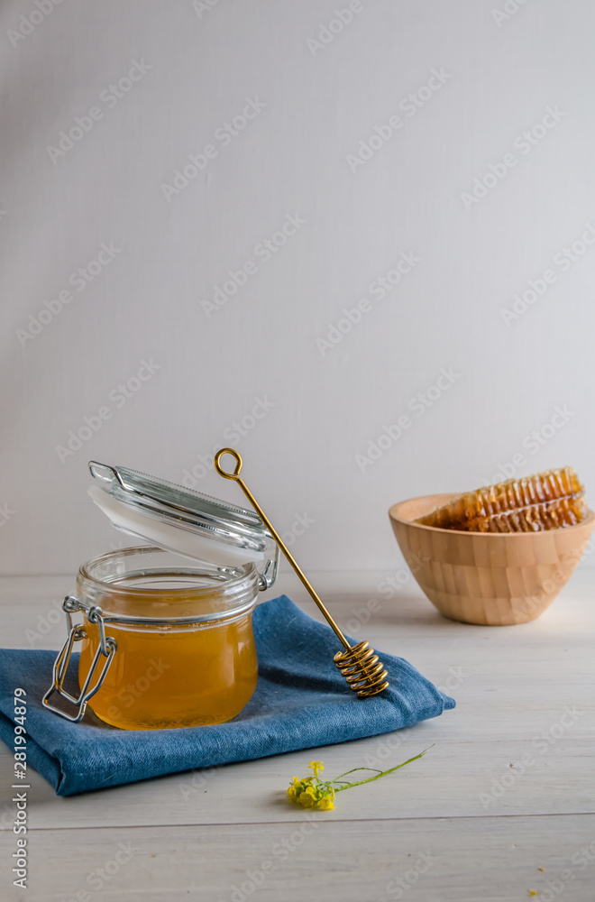 Fototapeta premium fresh honey and honeyons on a white background with copy space