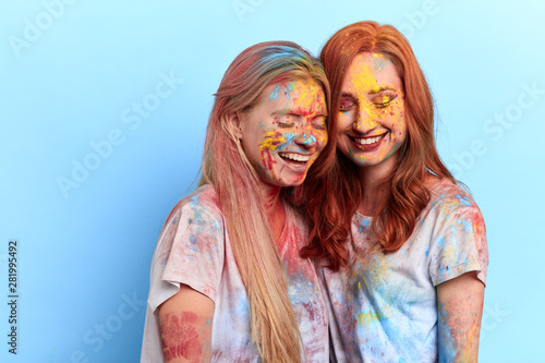 festive positive atmosphere of disobedience and irrepressible fun. close up portrait, isolated blue background, studio shot