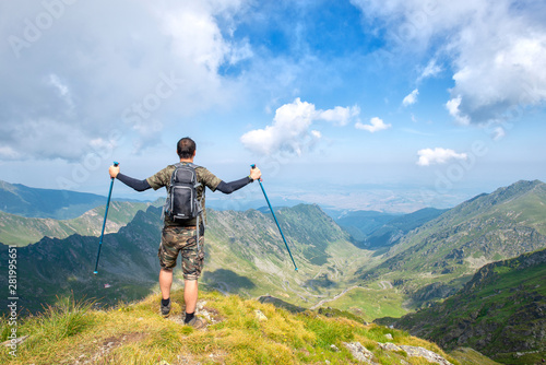 Successful active man hiker on top of mountain enjoying the view. Travel sport lifestyle concept