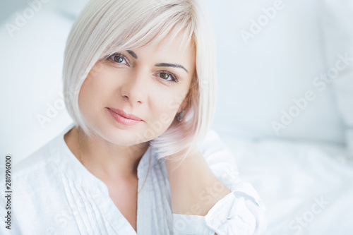 Closeup portrait of mature woman at home. Adult lady indoors. Beautiful midadult woman looking at camera. photo