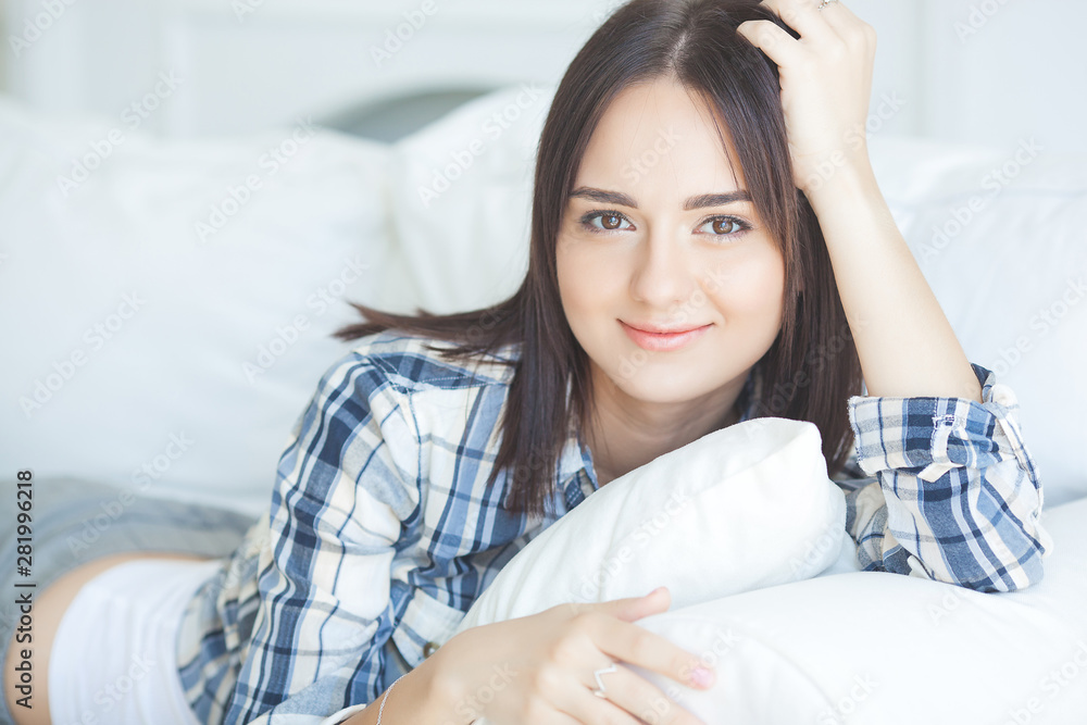 Portrait of young attractive brunette woman indoors. Beautiful lady on the couch. Female at the morning. Calm woman in weekend morning. Portrait of young attractive brunette woman indoors. Beautiful lady on the couch. Female at the morning. Calm woman in weekend morning.