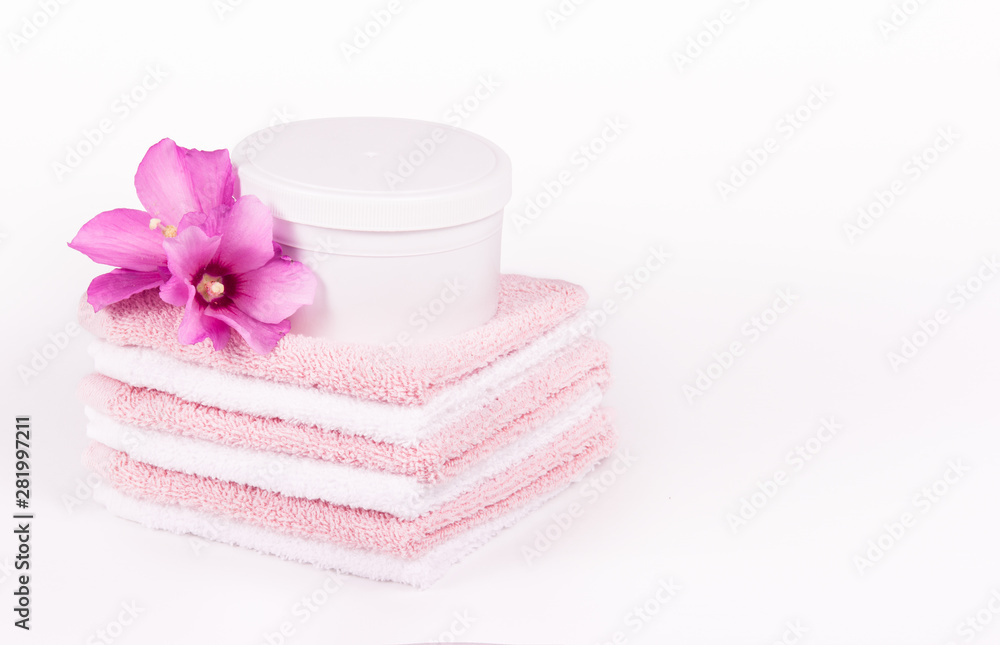 Soft towels and pink flowers. Mock-up jar spa cosmetics. Spa concept. Soft towels copy space Soft towels and pink flowers. Mock-up jar spa cosmetics. Spa concept. Soft towels copy space