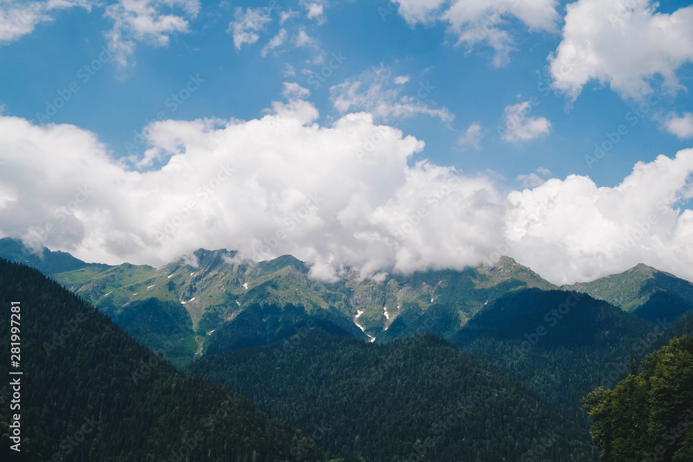Beautiful mountains in the clouds. Forests and mountain peaks Beautiful mountains in the clouds. Forests and mountain peaks