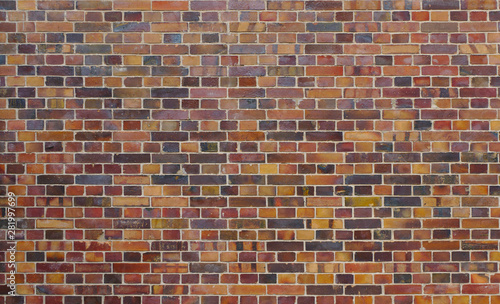 Texture of an old, weathered and colorful brick wall