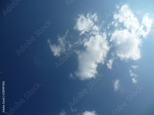 a white cloud flying along the blue sky
