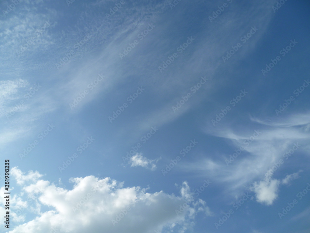 a white cloud flying along the blue sky