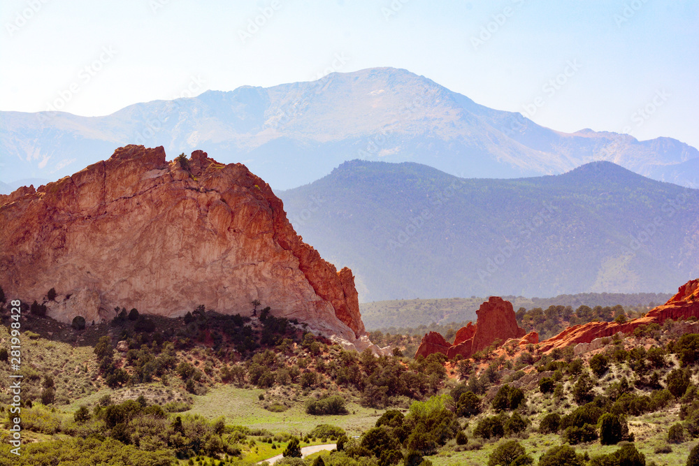 Wide angle landscape of desert, national park with rocky mountains behind natural rock formations