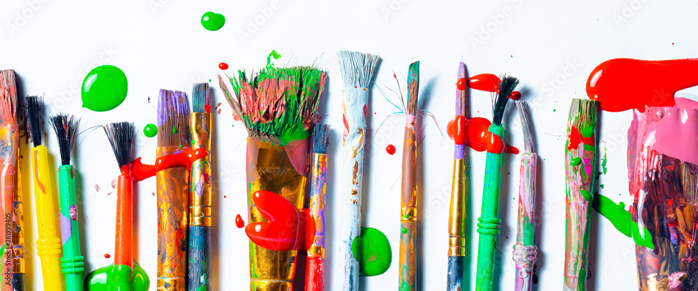 Row Of Messy Colorful Paint Brushes On Isolated White Background - Creativity Concept - obrazy, fototapety, plakaty 