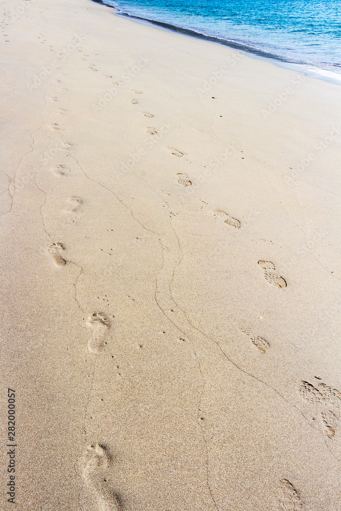 Pilgrims footsteps on Langosteira beach in Fisterra, Finisterre or End of the Earth, in A Coruna, Galicia, Spain on the Way of St. James, Camino de Santiago Pilgrims footsteps on Langosteira beach in Fisterra, Finisterre or End of the Earth, in A Coruna, Galicia, Spain on the Way of St. James, Camino de Santiago