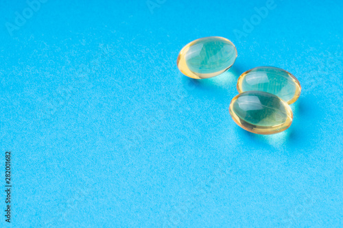 omega3 pills on a blue background. clouse up.