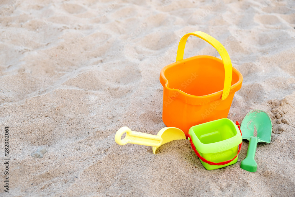 Children's toys lie on the sand on the beach. Family vacation on the beach. Children's toys lie on the sand on the beach. Family vacation on the beach.
