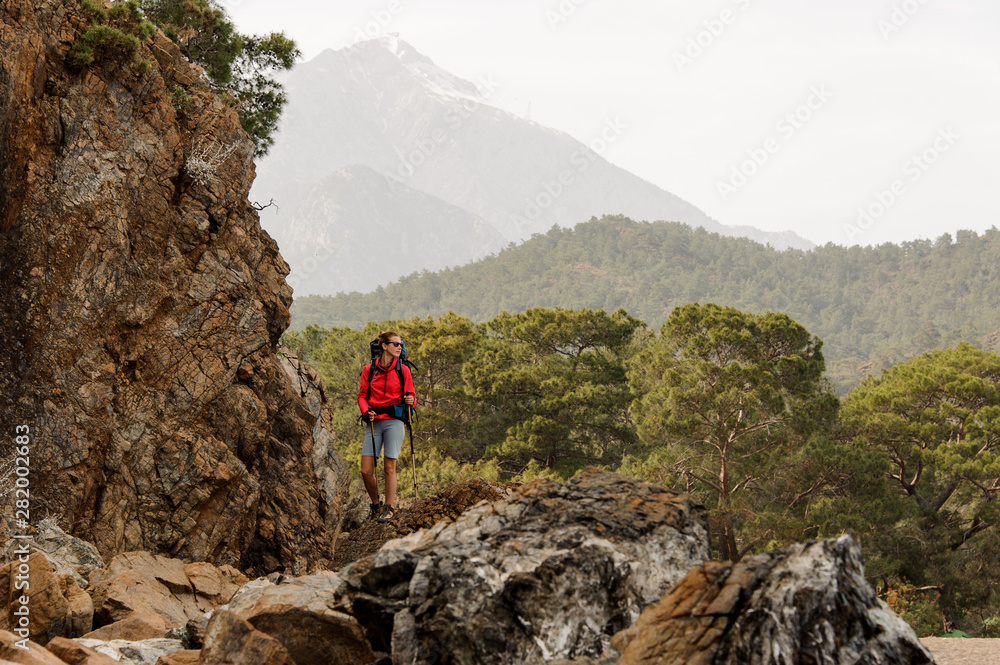 Female trekker stands on hills in Turkey