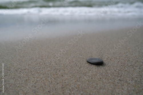 The dark stone on the sand