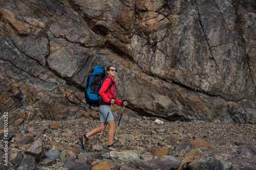 Female traveller walking in front of cliffs