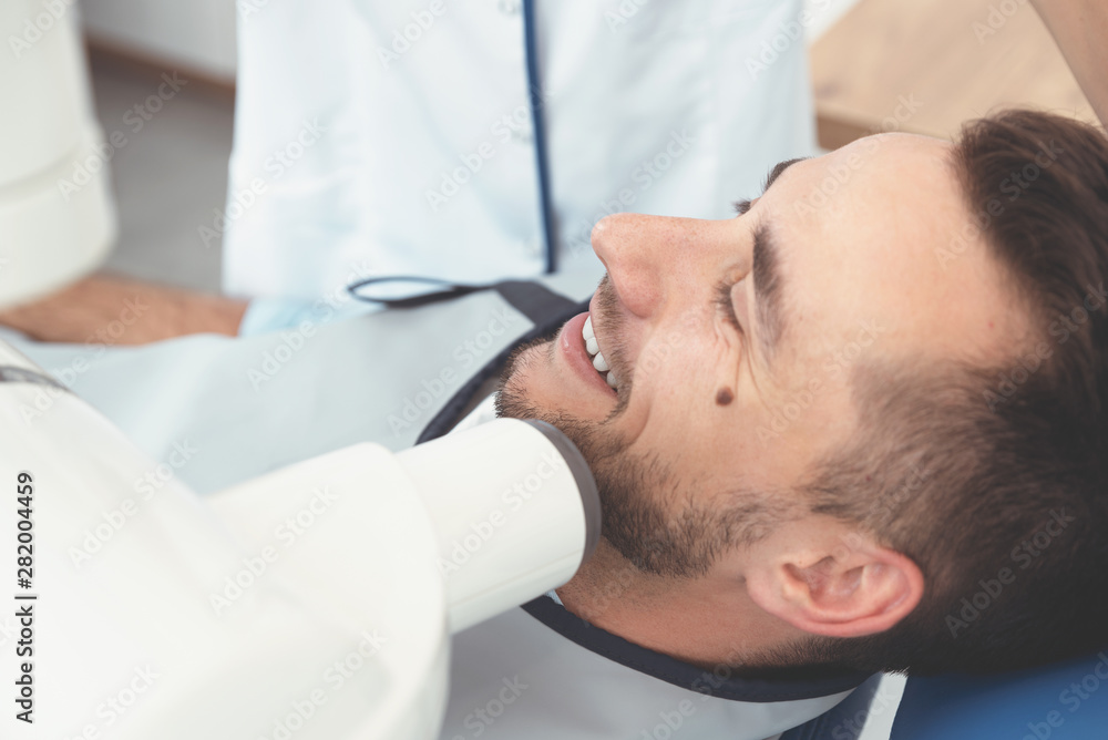 Dentist takes an x-ray picture of the tooth Dentist takes an x-ray picture of the tooth