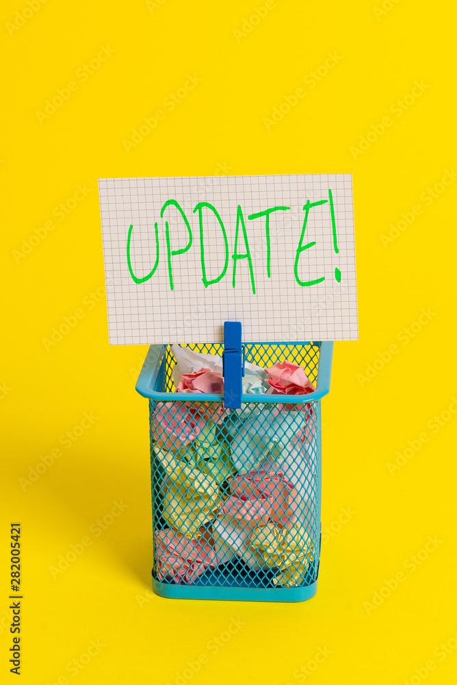 Obraz premium Text sign showing UPDATE. Business photo showcasing make something more modern or up to date like software program Trash bin crumpled paper clothespin empty reminder office supplies yellow