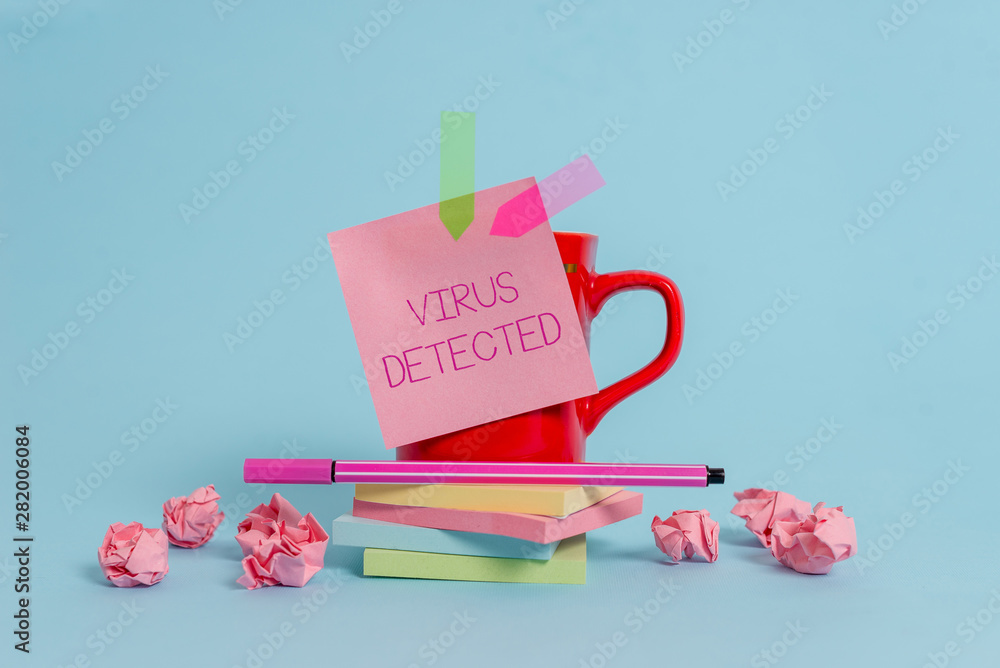 Writing note showing Virus Detected. Business concept for A computer program used to prevent and remove malware Coffee cup pen note banners stacked pads paper balls pastel background