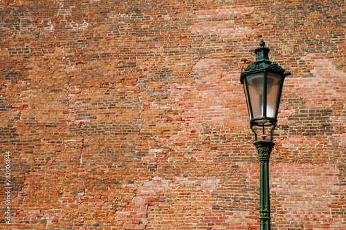 Street lamp on brick wall background