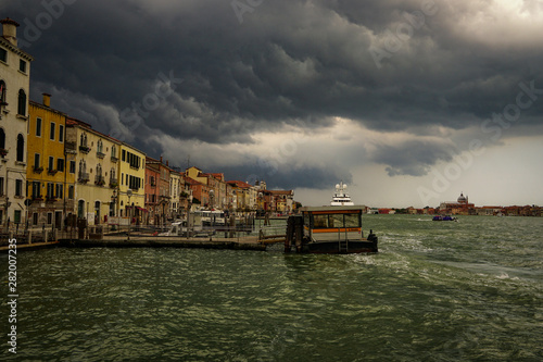 VENICE, ITALY - JULY,5: Stormy day in the center of Venice, boats, buildings, bridges under the heavy clouds