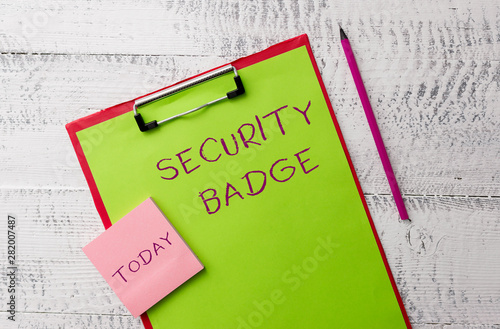 Word writing text Security Badge. Business photo showcasing Credential used to gain accessed on the controlled area Metal clipboard paper sheets marker sticky notes pad wooden background