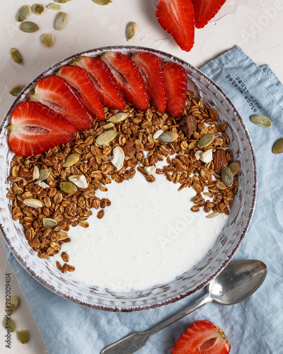 Granola with strawberries, nuts, pumpkin seeds and yogurt