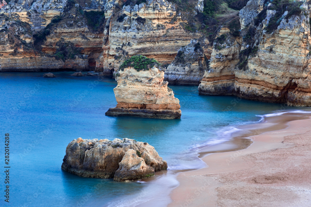 Fototapeta premium Rock formations in the beautiful beach of Praia Dona Ana, Lagos, Portuga