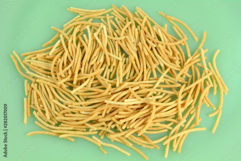 Close up of heap of crispy rice noodles on green plate Close up of heap of crispy rice noodles on green plate