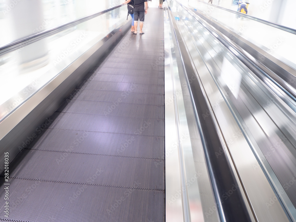 skywalk with blurred business people in airport skywalk with blurred business people in airport